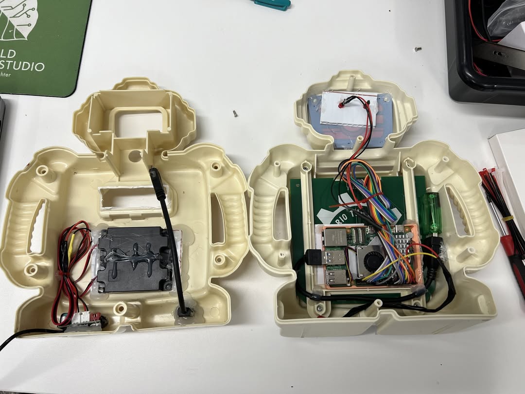 Alphie robot opened up showing Raspberry Pi and internal electronics