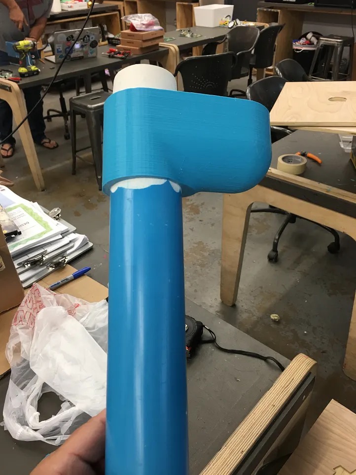 Blue 3D-printed limb sitting on the workbench during fabrication